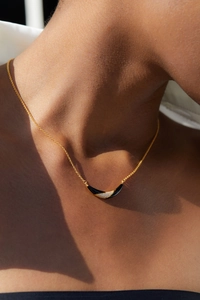Detail of 925 silver 18K gold necklace featuring a black onyx and pave zircon smile pendant