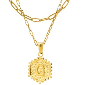 Detailed view of golden double-layer paperclip chain with hexagonal letter G pendant