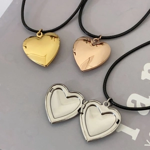 Polished heart locket necklaces in gold, rose gold and silver on black cords