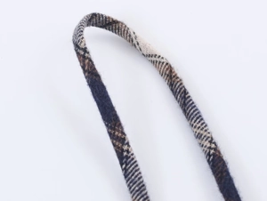 Close-up detail of British style navy and khaki plaid fabric strap with fine textile texture