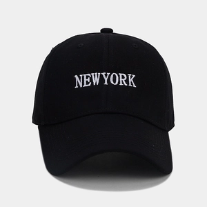 Close-up of NEW YORK white embroidery and cotton canvas texture on black baseball cap