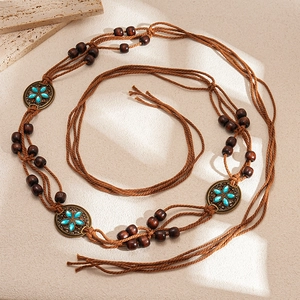Detail of bohemian waist chain with wooden beads and turquoise bronze flower accents