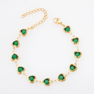 Detailed view of heart-shaped green glass inlays with gold-plated titanium steel chain