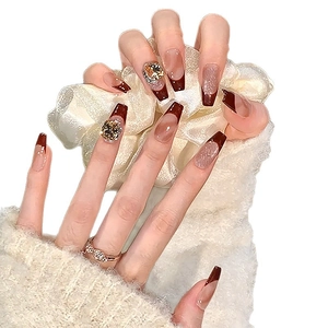 French tip coffin fake nails with brown marble patterns and sparkling 3D rhinestones