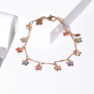 Elegant gold butterfly bracelet with colorful crystal pendants on a white background