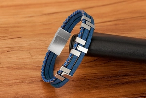Macro shot of blue braided leather bracelet with silver brushed stainless steel clasp
