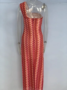 Detail of slim fit one-shoulder lace dress with red and pink wavy knit patterns