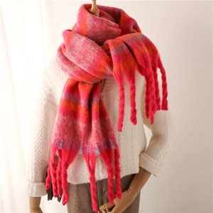 Pink striped plaid winter scarf with thick tassels and soft cashmere-like texture on model
