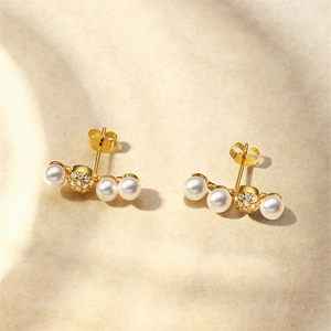 Macro detail of S925 silver gold pearl stud earrings with zircon curved smile fan design