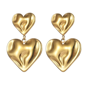 Irregular textured gold double heart earrings with smooth metallic finish on white background