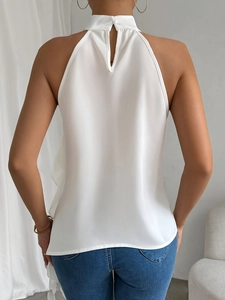 Elegant white halter neck backless top for women shown from the back with denim jeans