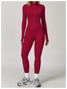 Detail of burgundy long sleeve yoga jacket with zipper and thumb holes for women