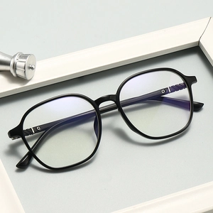 Macro shot of stylish black full-frame glasses with silver hinges on minimalist background