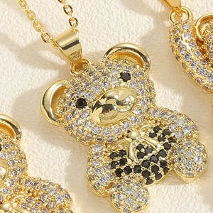 Macro shot of bear pendant necklace with white and black cubic zirconia in gold