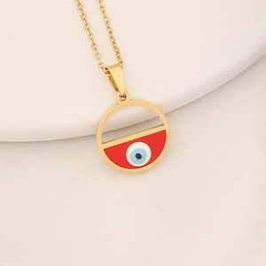 Detailed shot of golden necklace with red enamel and blue evil eye pendant detail