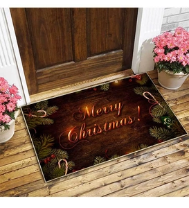 Detailed view of Merry Christmas doormat with red lettering and festive greenery decor