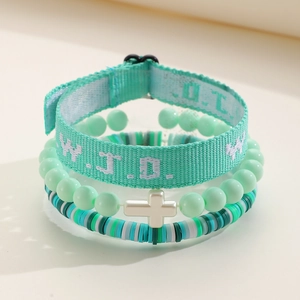Detail of mint green beaded bracelet set with silver cross and WWJD woven band