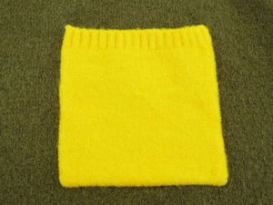 Detail of yellow mohair knit neck warmer with ribbed texture and fuzzy cashmere finish