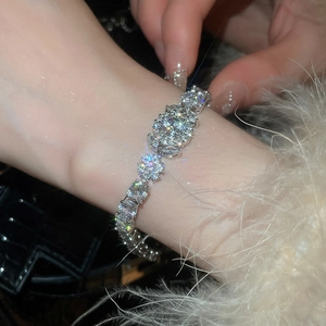 Macro close-up of a silver floral zircon bracelet featuring sparkling crystal cluster detail