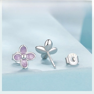 Close-up of S925 sterling silver stamp on purple flower stud earring and butterfly back