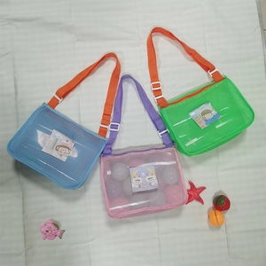 Detailed view of colorful shell-shaped mesh beach bags with cartoon patches and straps