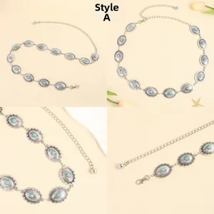 Detail of bohemian metal waist chain featuring turquoise stones and vintage engraving