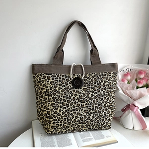 Detail of leopard print canvas tote with corduroy trim and decorative black button