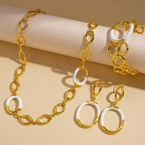 Parure de bijoux rétro émaillée or et blanc avec collier, boucles d'oreilles et bracelet