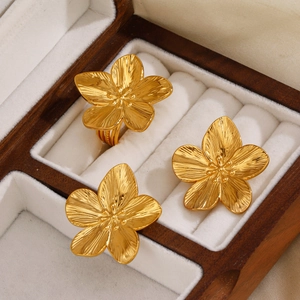 Gold flower jewelry set with earrings and ring in a luxury wooden display box