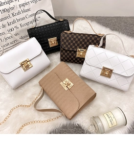Detailed flat lay of five textured chain crossbody bags with gold metal turn-lock closure