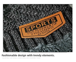 Macro shot of dark grey knit hat with thick fleece lining and leather brand label