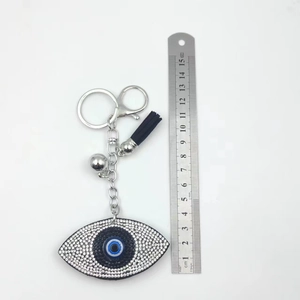 Detail shot of Evil Eye keychain with ruler showing total length of 8.5cm and black tassel