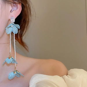 Detail of blue lace floral long tassel earrings with pearls and crystals on ear