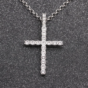 Silver tone cross necklace pendant featuring clear circular gemstones on a sleek chain