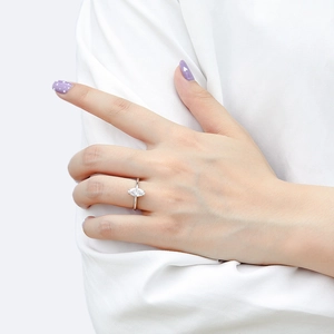 Detail of marquise-cut zircon ring on finger with elegant silver band and claw setting