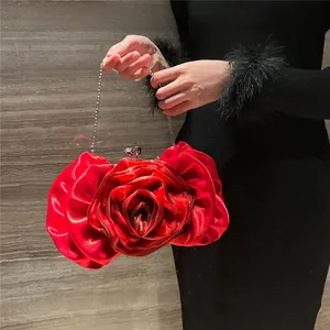 Detailed view of luxury red rose silk evening bag with crystal clasp and silver chain
