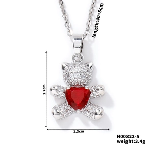 Detail of silver bear pendant with red heart zircon and white stone pave setting
