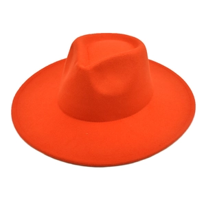 Top view of bright orange wide brim wool fedora hat with teardrop crown detail