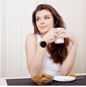 Classic women's watch with black dial and brown leather strap in an elegant setting