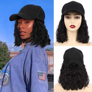 Detail view of black baseball cap with integrated long wavy synthetic hair extensions