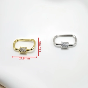 Detailed close-up of zircon-encrusted carabiner screw clasps in gold and silver finishes