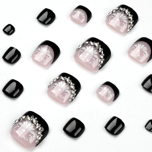 Elegant black and pink press-on toenails set with white flowers and rhinestone accents