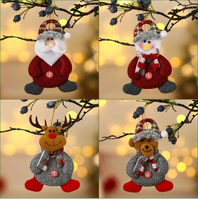 Detail of four Christmas plush ornaments featuring Santa and Snowman on tree branches