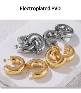 Detailed macro view of PVD electroplated C-shape hoop earrings in gold and silver finish