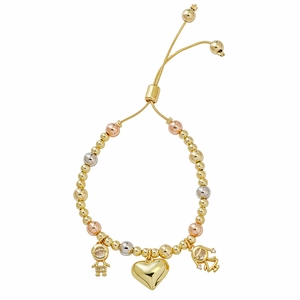Detail of beaded bracelet with gold, silver and rose gold charms of boy, heart and girl