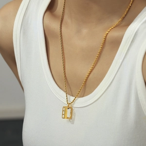 Chic gold twisted chain necklace with square zircon pendant worn by female model
