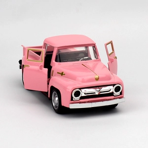 Pink vintage toy pickup truck model with open doors and silver-gold metallic accents