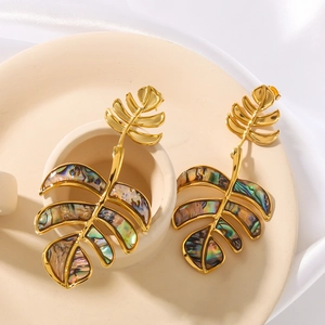 18K gold plated monstera leaf earrings with shell inlay on beige ceramic and silk