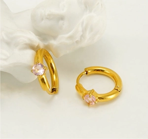 Close-up of gold stainless steel hoop earrings with inlaid pink zircon and four-prong setting