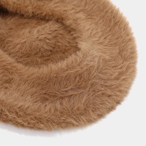 Close-up of caramel brown plush beret showing dense and warm faux fur texture